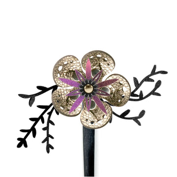 A wood hair stick featuring a large gold faux leather flower accented by black leaves shown on a white background