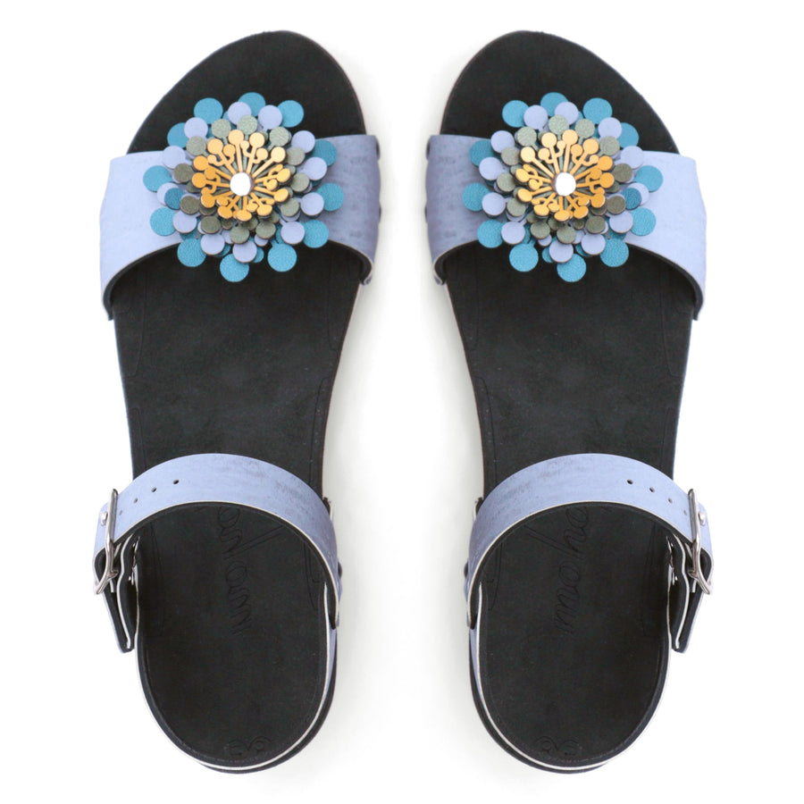 Top view of a sandal in arctic with an abstract floral pompom at the toe