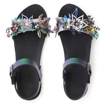 Top view of sandals with a a 3D laser cut floral motif in a rainbow of colors