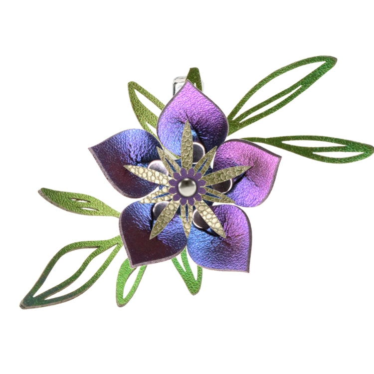 A custom designed vegan flower barrette featuring green leaves and a large iridescent blue flower.