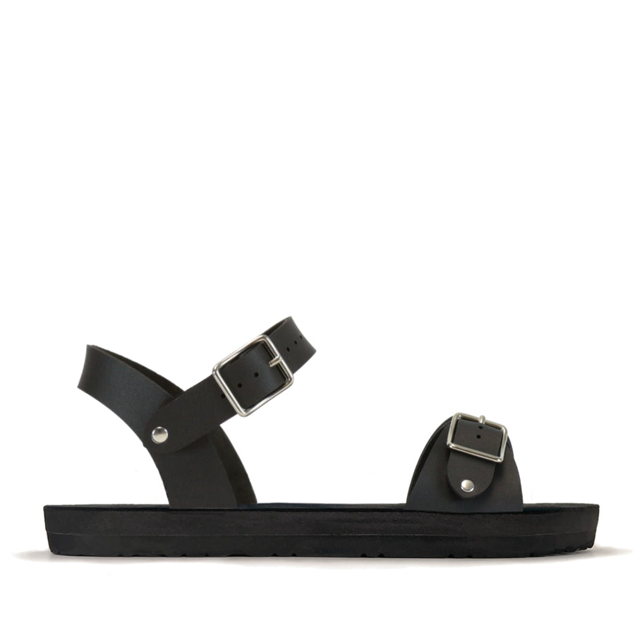 Side view of a flat, padded vegan sandal in matte black with an ankle strap
