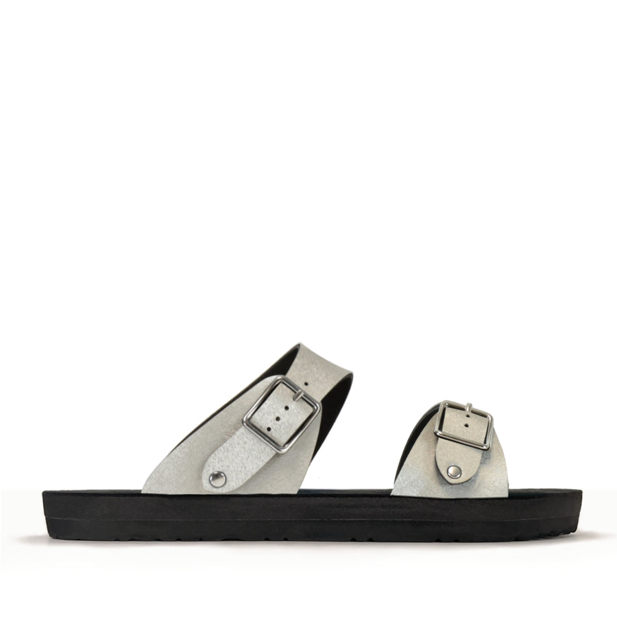 Side view of a flat, padded vegan sandal in champagne color
