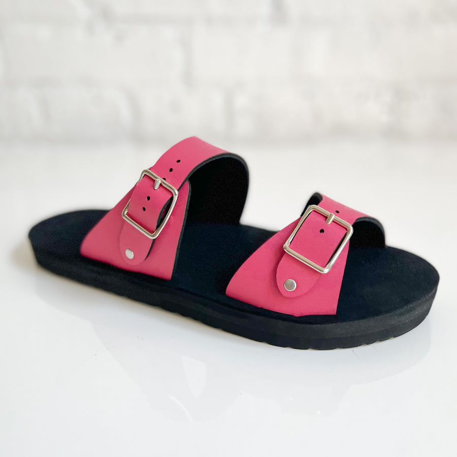 Angle view of a flat, padded vegan sandal in hot pink