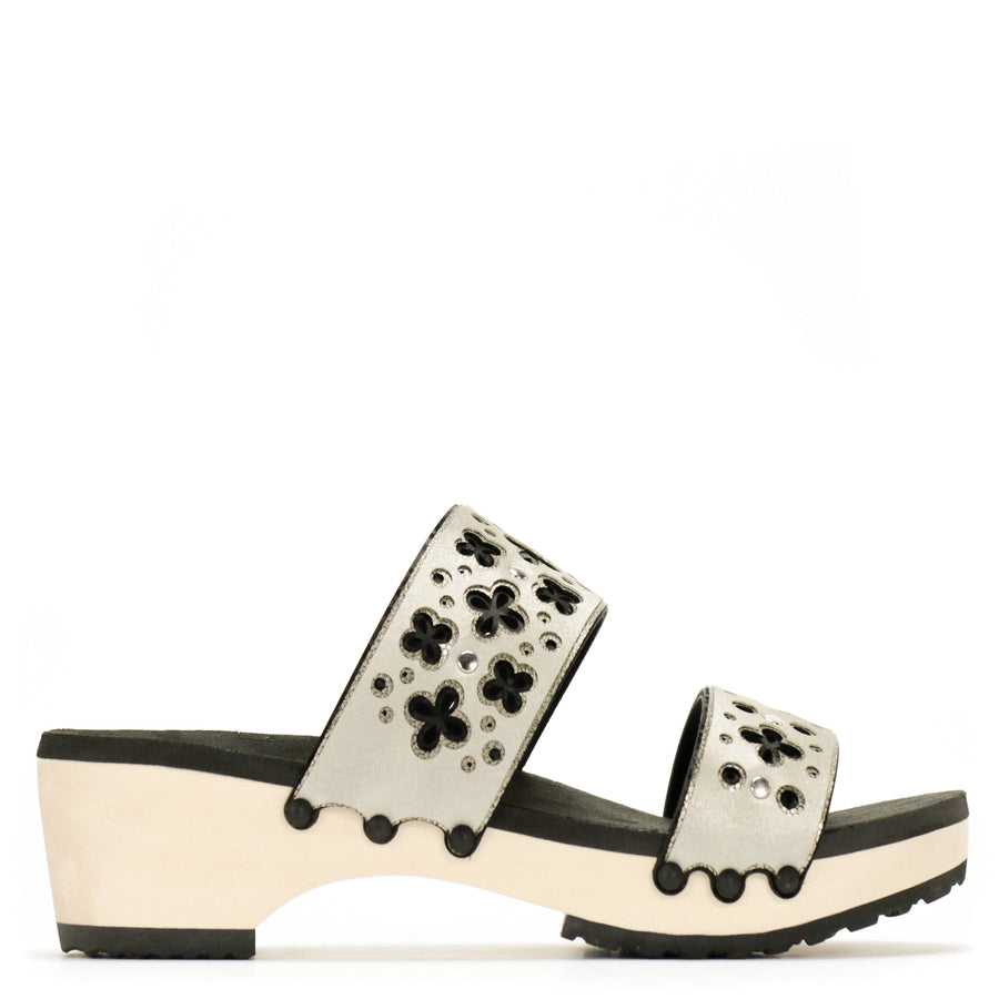 Side view of a sandal with laser cut layers in black and metallics