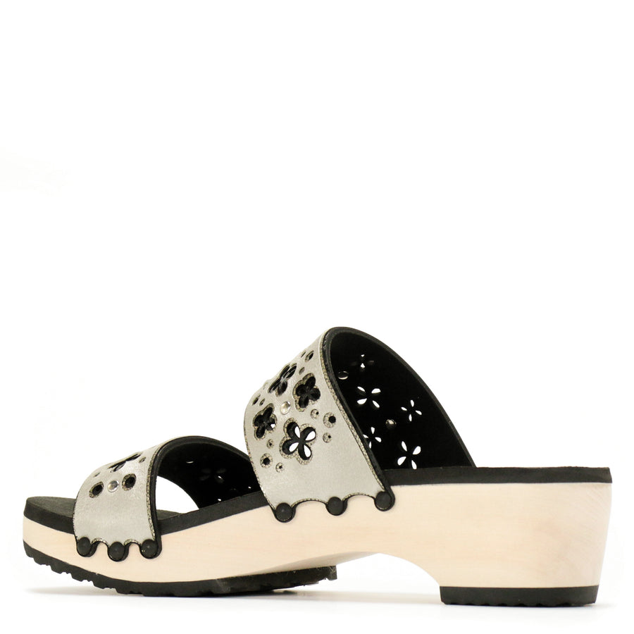Back view of a sandal with laser cut layers in black and metallics