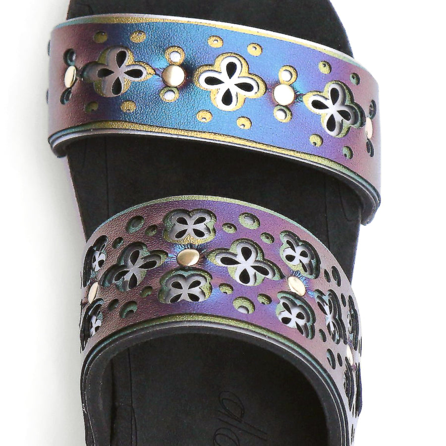 Detail view of a iridescent blue laser cut sandal with multiple layers