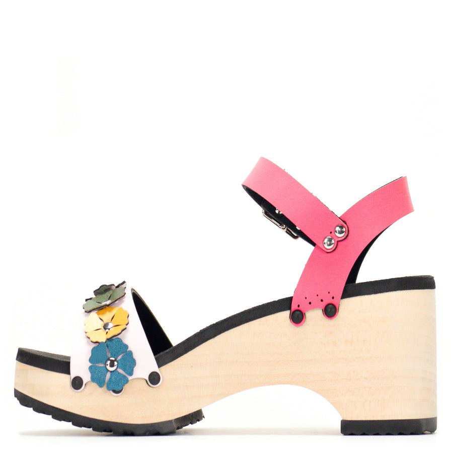 Instep view of a sandal with7 simple colorful flowers and a hot pink ankle strap