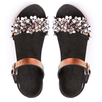 Top view of a sandal with a silver sparkly toe and red adjustable ankle strap