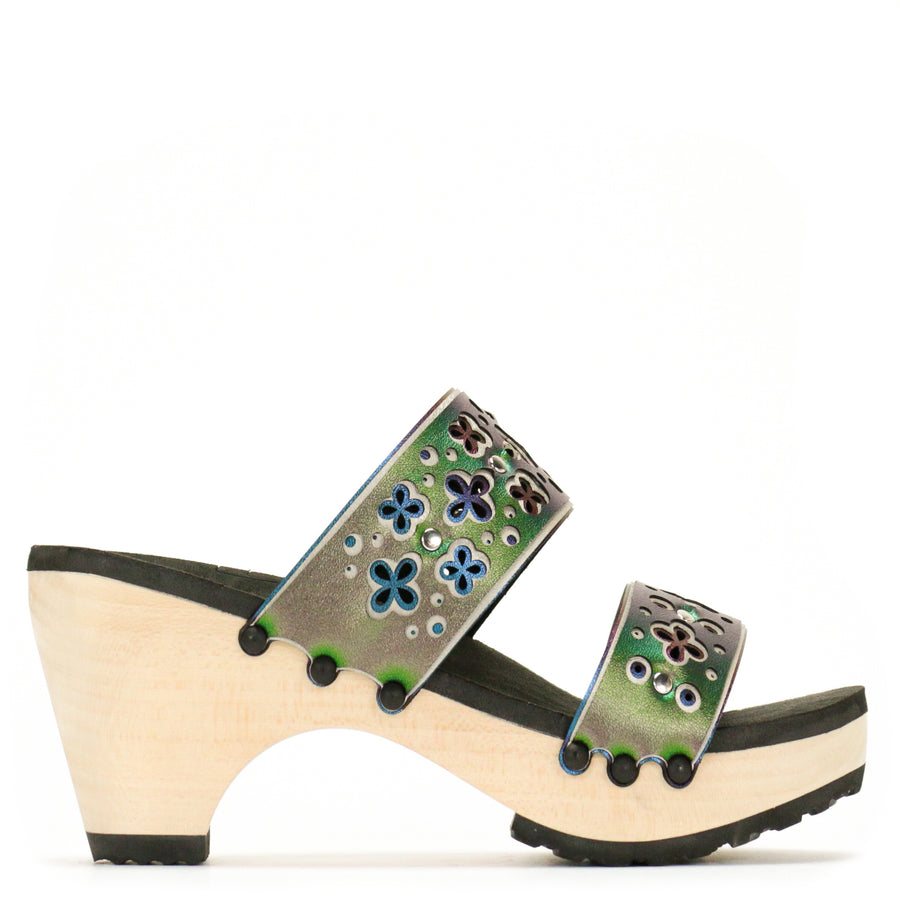 Side view of a sandal with layers of laser cut material in greens and blues