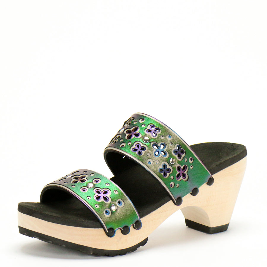 3/4 view of a sandal with layers of laser cut material in greens and blues