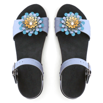 Top view of a sandal in arctic with an abstract floral pompom at the toe