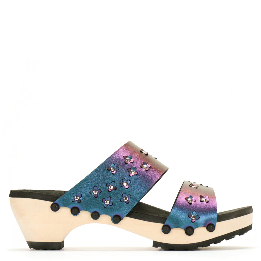 Side view of sandals in iridescent blue with tiny laser cut flowers sprinkled on the upper