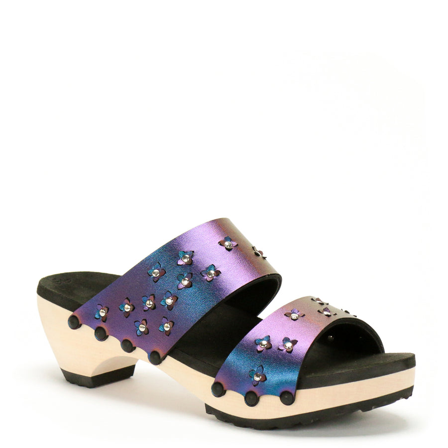 3/4 view of sandals in iridescent blue with tiny laser cut flowers sprinkled on the upper