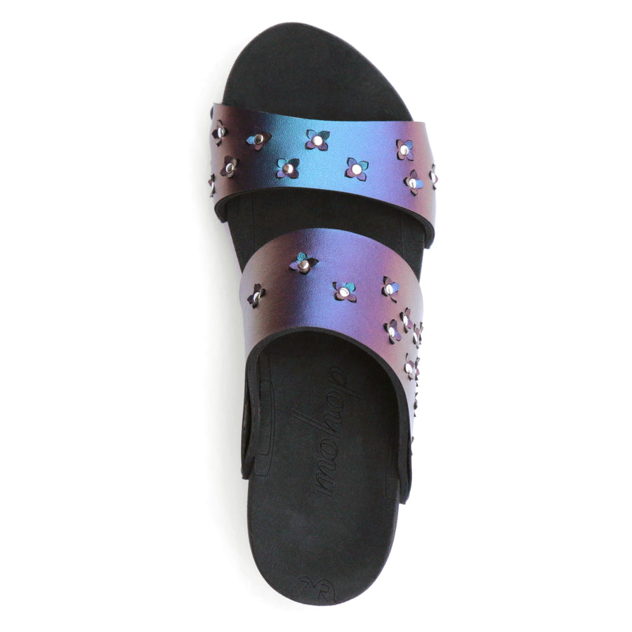 Top view of sandals in iridescent blue with tiny laser cut flowers sprinkled on the upper