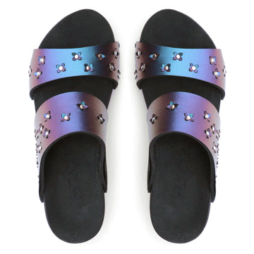 Top view of sandals in iridescent blue with tiny laser cut flowers sprinkled on the upper