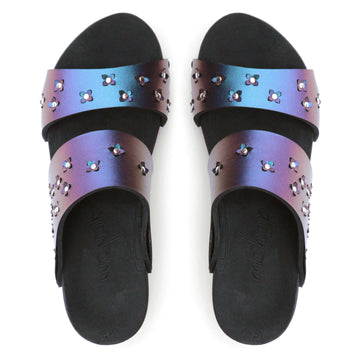 Top view of sandals in iridescent blue with tiny laser cut flowers sprinkled on the upper