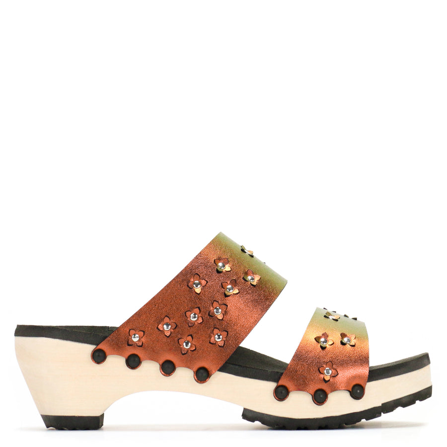 Side view of sandals in iridescent red with tiny laser cut flowers sprinkled on the upper