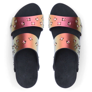 Top view of sandals in iridescent red with tiny laser cut flowers sprinkled on the upper