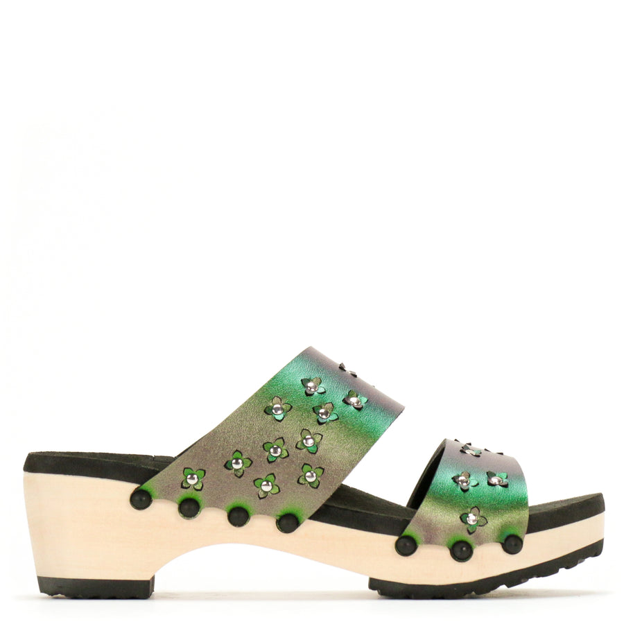 Side view of sandals in iridescent green with tiny laser cut flowers sprinkled on the upper