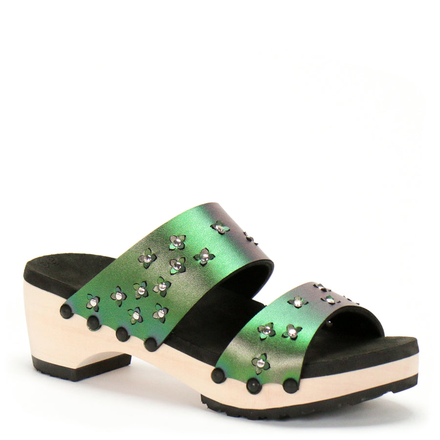 3/4 view of sandals in iridescent green with tiny laser cut flowers sprinkled on the upper