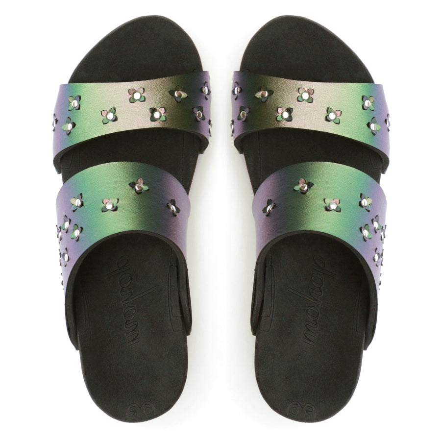 Top view of sandals in iridescent green with tiny laser cut flowers sprinkled on the upper