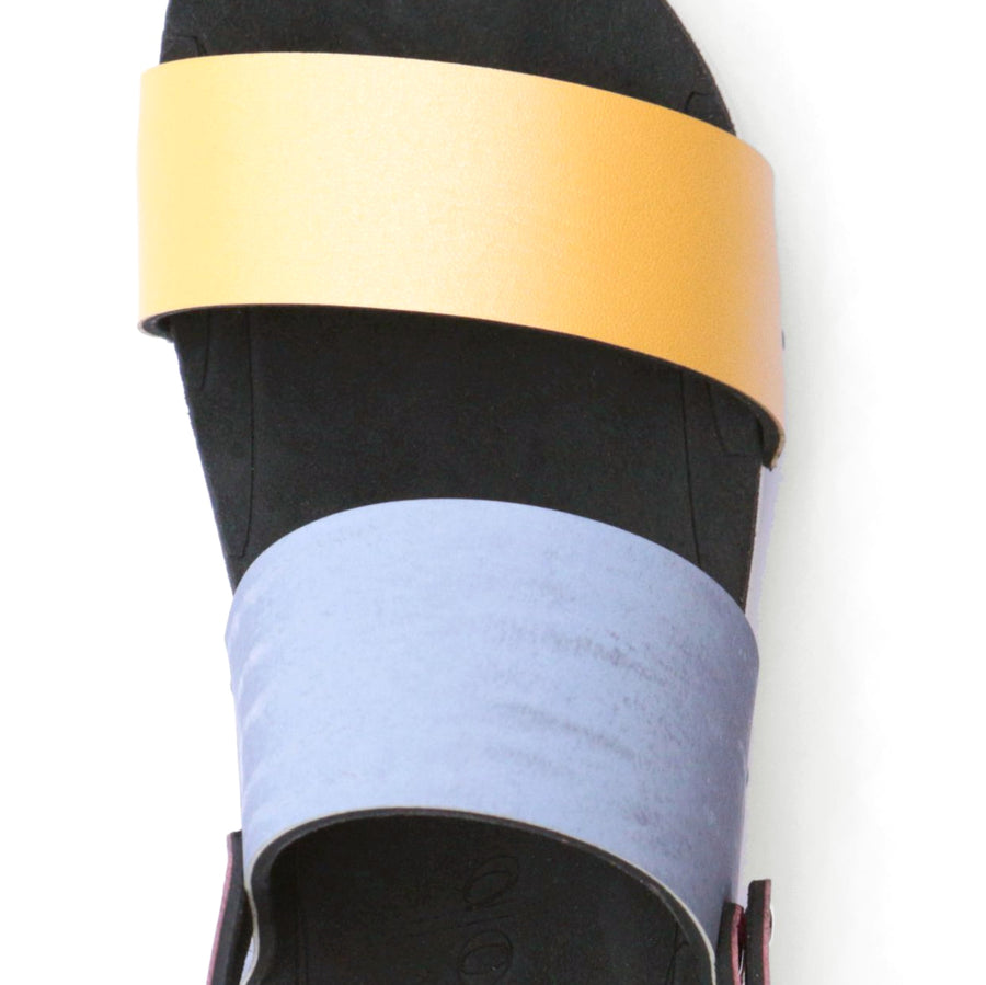 Detail view of sandals with colorblock straps in pink, yellow, green and light blue