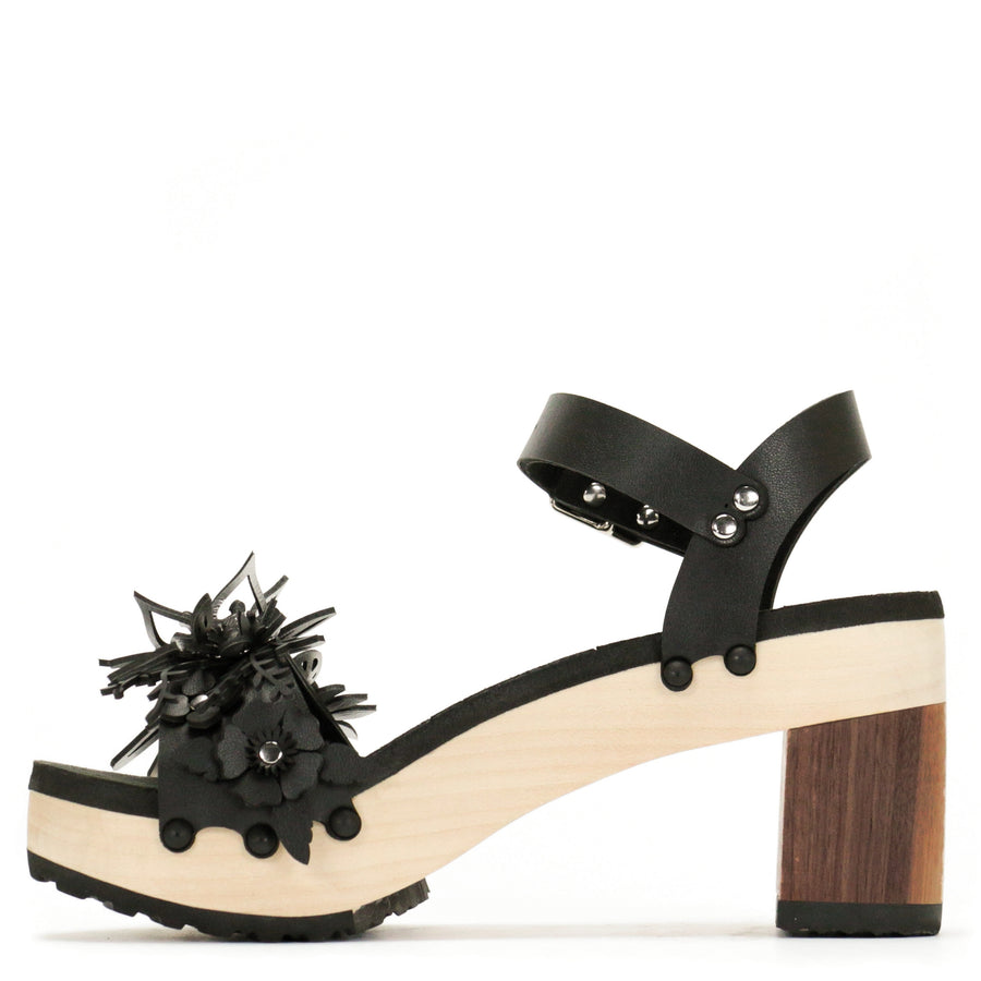 Inside view of a sandal with laser cut flowers in matte black