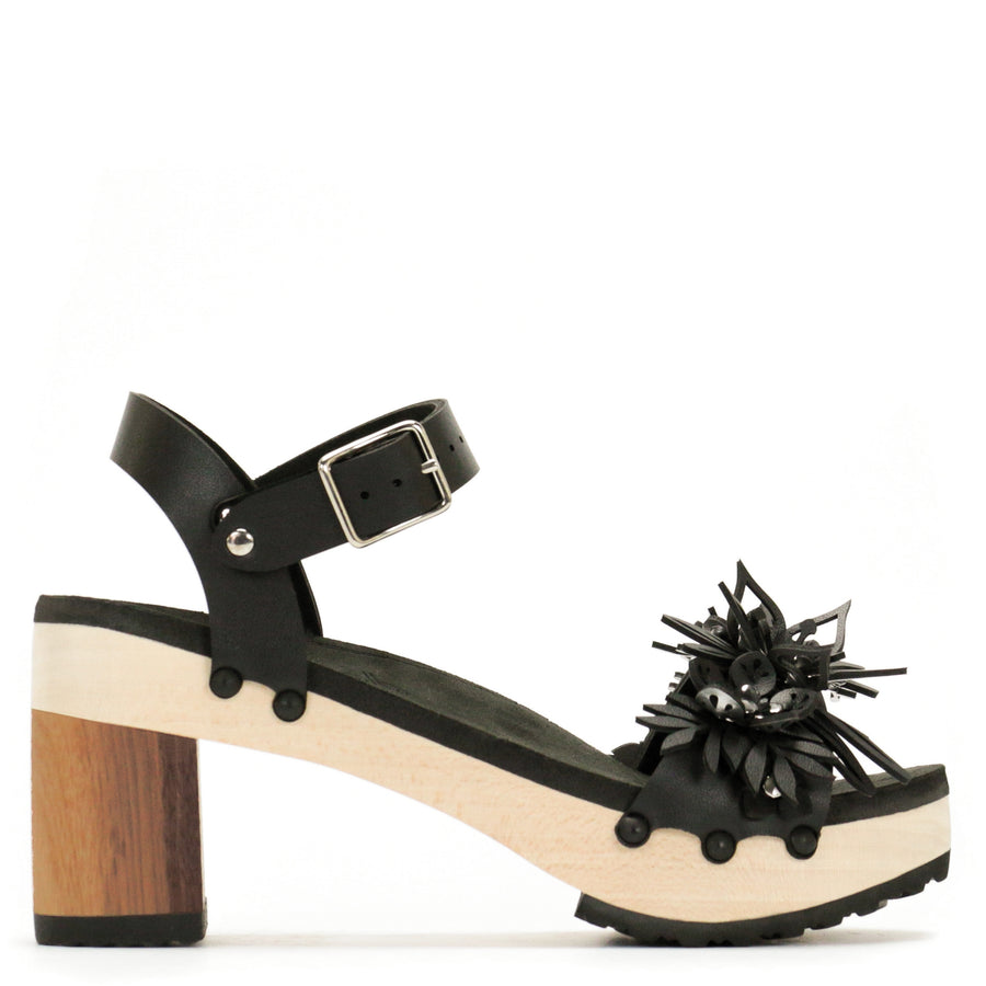 Outside view of a sandal with laser cut flowers in matte black