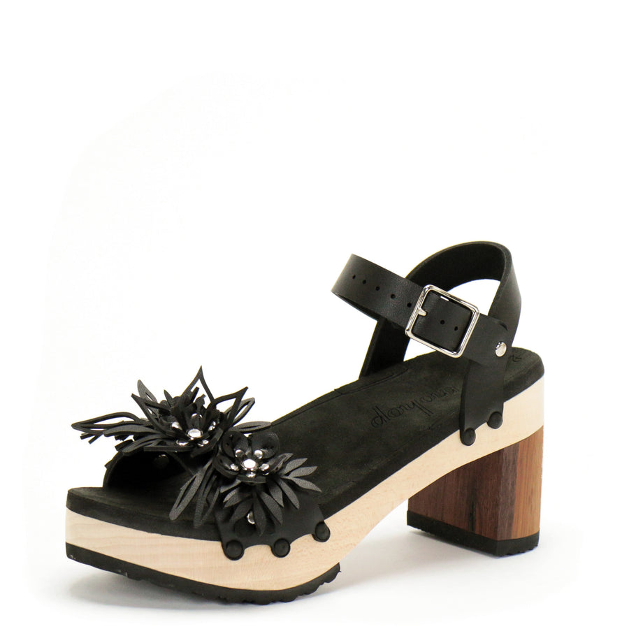 3/4 view of a sandal with laser cut flowers in matte black