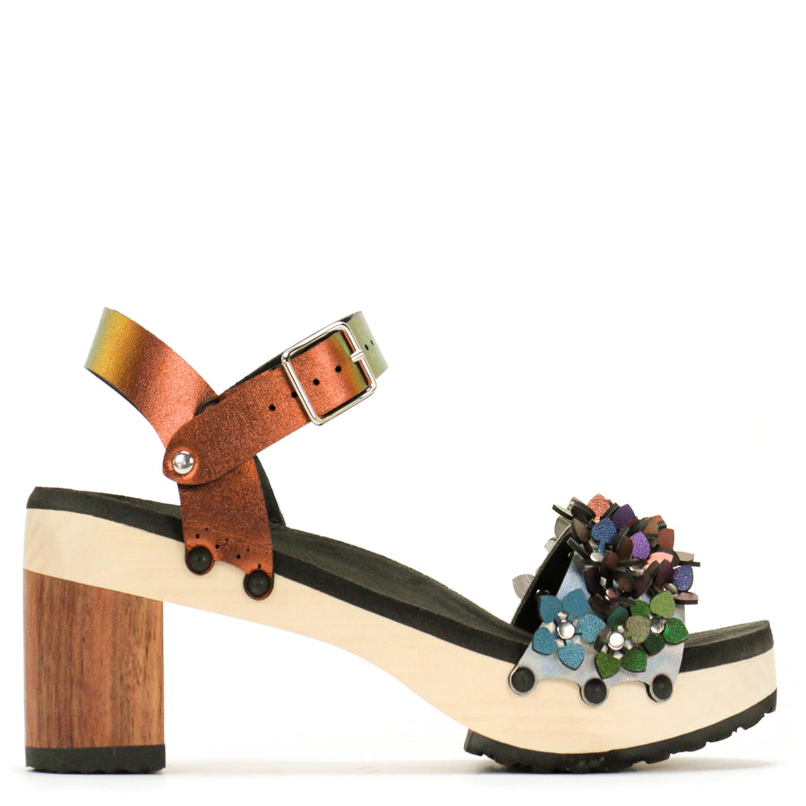 Side view of a sandal with a rainbow toe and red ankle strap