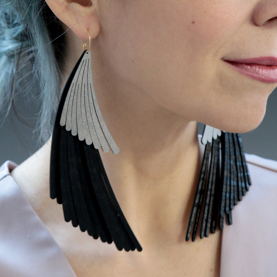 Two tier wing fringe earrings. Made in Chicago using black and silver vegan leather.
