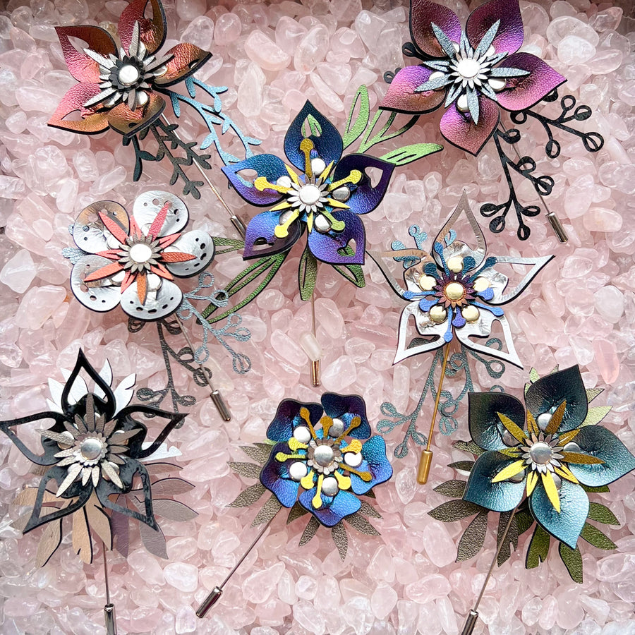 Multiple stick pins with 3D laser cut flowers in various iridescent colors