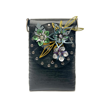 A small bag in black chinchilla vegan leather with a 3D floral laser cut front flap 