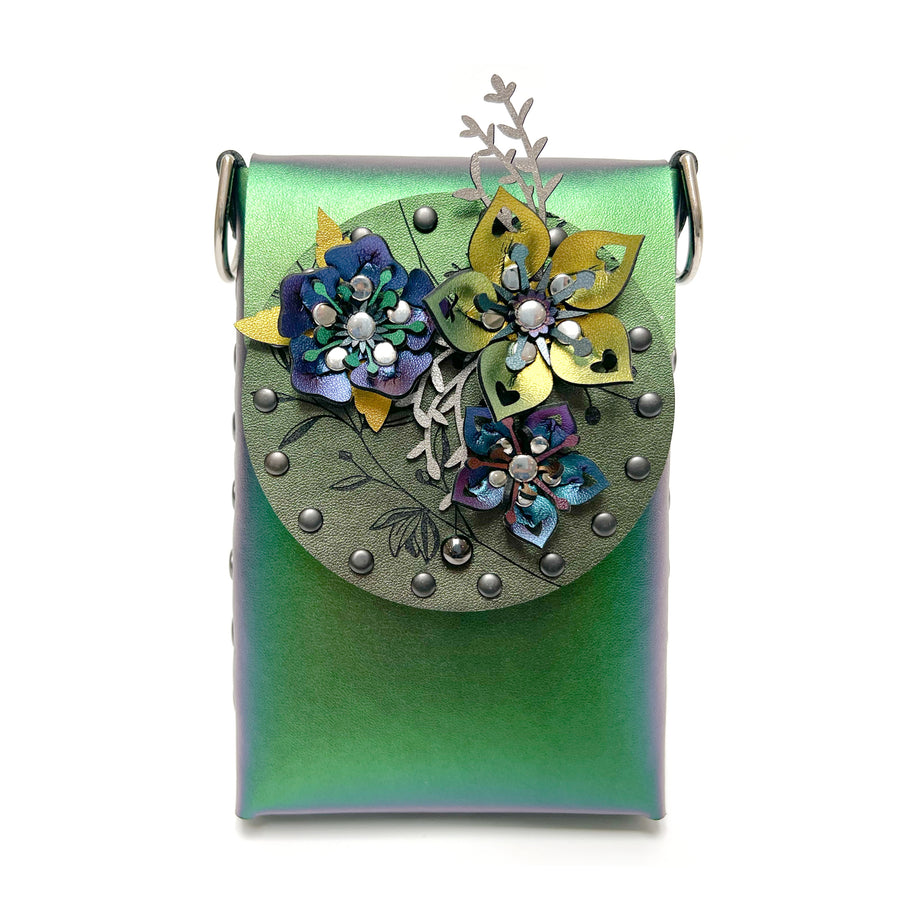 A small bag in green iridescent vegan leather with a 3D floral laser cut front flap