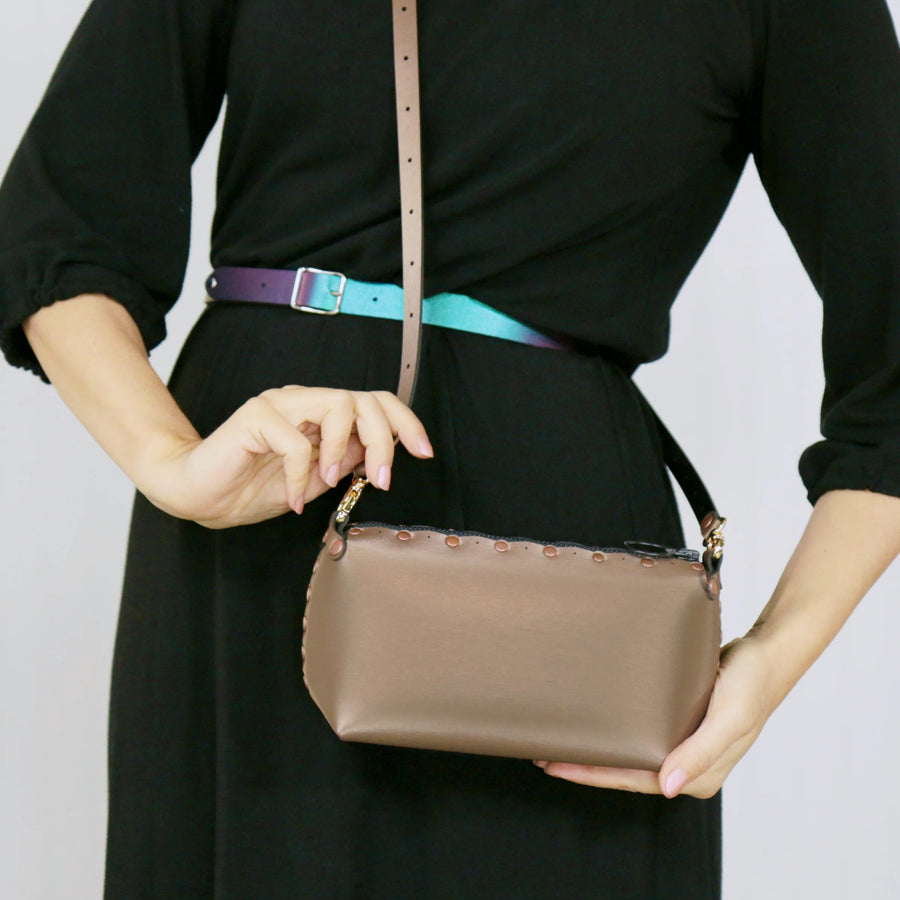 Model wearing mocha mini bag with crossbody strap