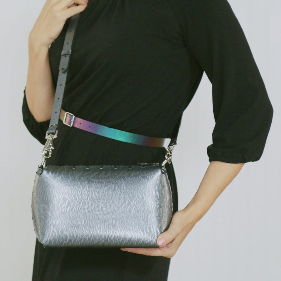 Model wearing a pewter small crossbody bag