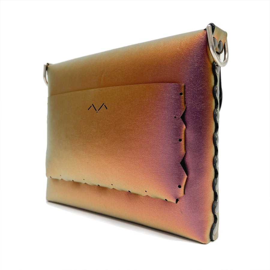 Rear angle view of the Ruby Square Bubble Bag. The decorative details of the exterior rear pocket are highlighted along side the iridescent color shifting vegan leather.